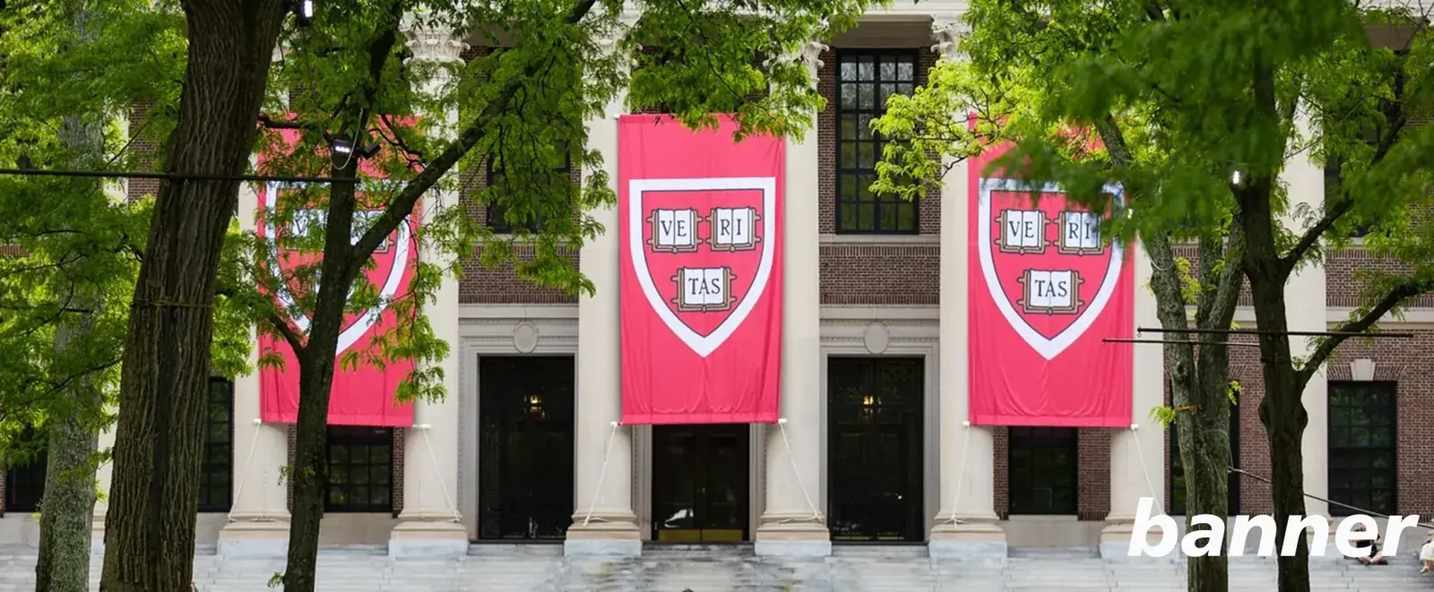 Large custom printed banners hanging on a university building facade