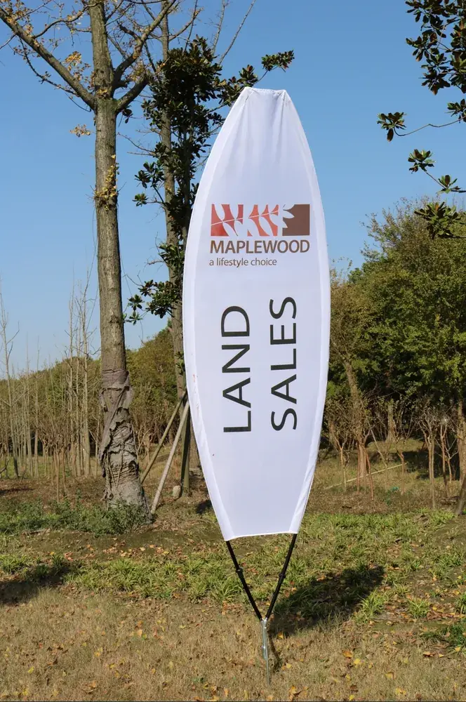 Wolflag factory-direct custom feather flag （leaf-shaped） for Maplewood land sales, a printed outdoor advertising flag for real estate promotions.